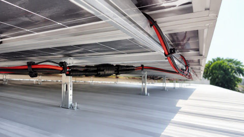 PV wire runs with MC4 connectors under a rooftop solar array