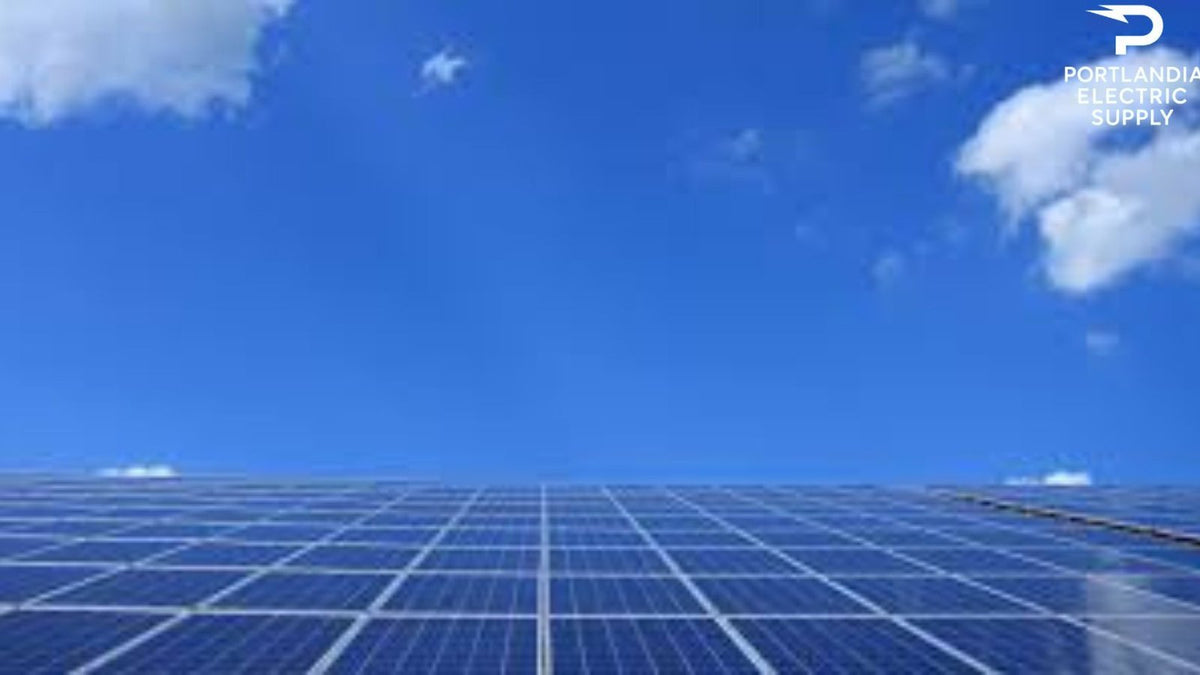 Solar panels installed under blue sky with clouds, Portlandia Electric Supply logo visible