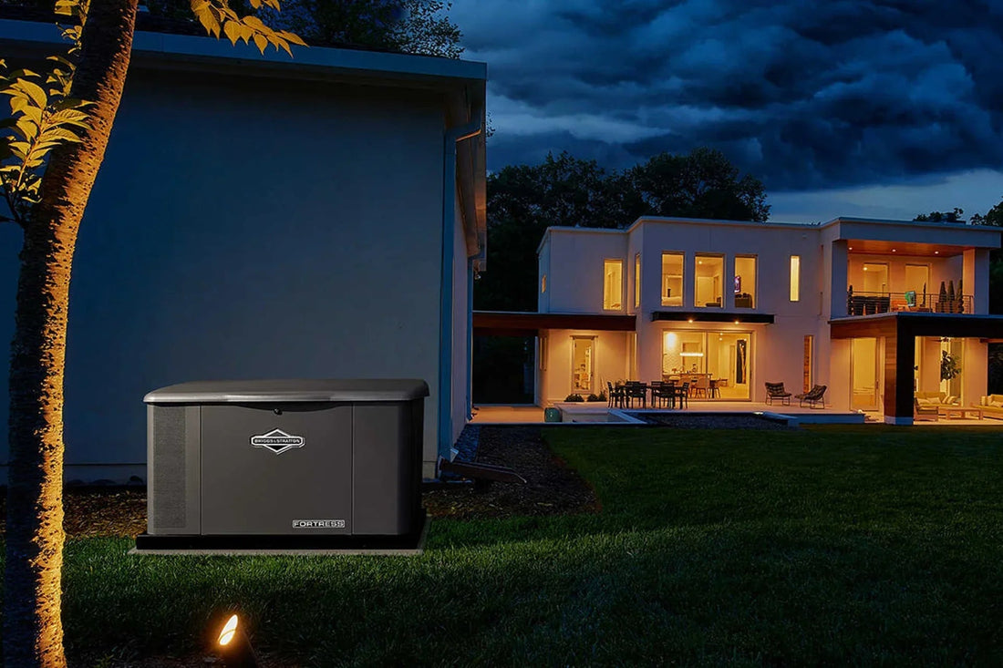 Backup generator outside modern house with illuminated windows at night