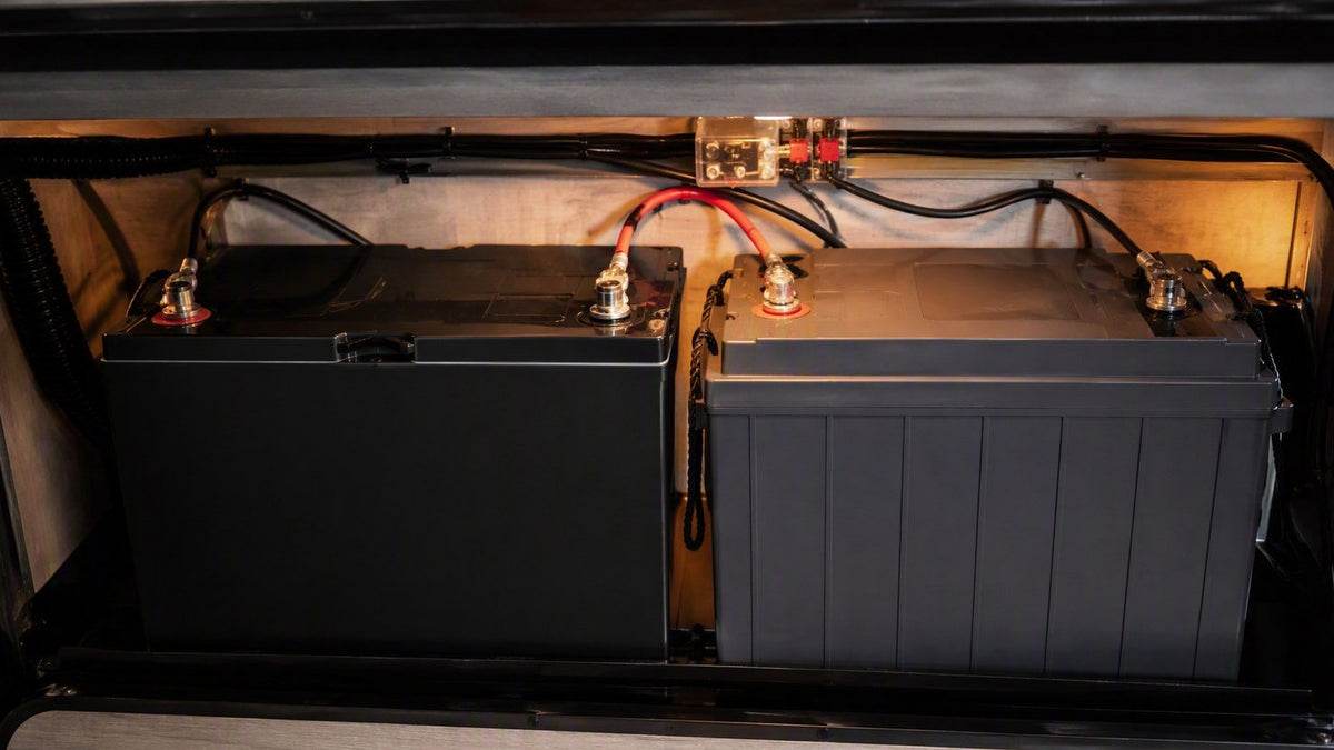 Two 12V LiFePO4 batteries side by side in an RV battery compartment