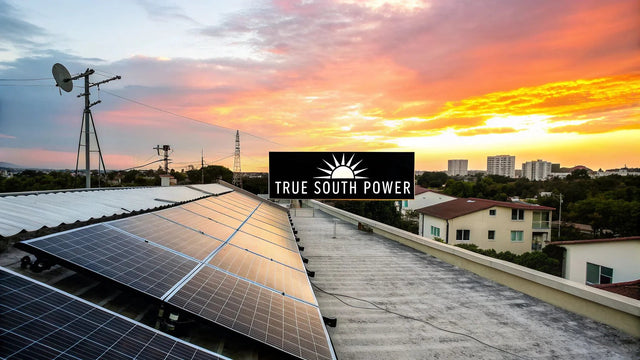 Rooftop solar panels by True South Power at sunset, urban skyline in background