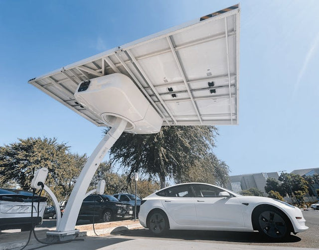 White electric car charging at outdoor solar-powered EV charging station in parking lot