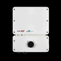 SolarEdge SE7600H HD-Wave inverter front view, white casing, single black dial, on black background